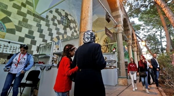 Visitors tour a trade fair dedicated to war-hit businesses from Aleppo looking to make a revival in Damascus. AFP Visitors tour a trade fair dedicated to war-hit businesses from Aleppo looking to make a revival in Damascus. AFP