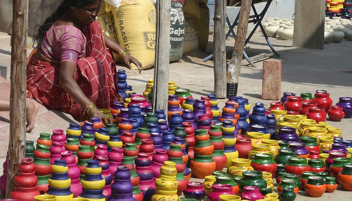 An artisan arranges earthenware oil pots or diyas for drying ahead of Diwali, the Hindu festival of lights, outside a workshop in Hyderabad, India. AFP An artisan arranges earthenware oil pots or diyas for drying ahead of Diwali, the Hindu festival of lights, outside a workshop in Hyderabad, India. AFP