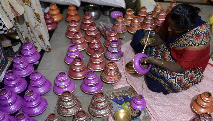 An artisan applies colors on earthenware oil pots or diyas ahead of Diwali, the Hindu festival of lights, at a workshop in Hyderabad, India. AFP An artisan applies colors on earthenware oil pots or diyas ahead of Diwali, the Hindu festival of lights, at a workshop in Hyderabad, India. AFP