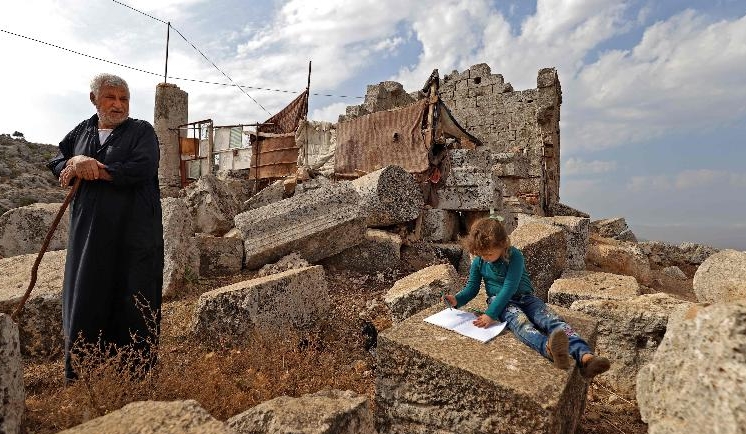 Displaced Syrians in their makeshift camp amidst Roman ruins in Baqirha. AFP Displaced Syrians in their makeshift camp amidst Roman ruins in Baqirha. AFP