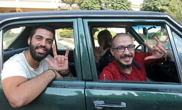 Bader (R) and Ahmad Moussa during a car ride in Damascus. AFP