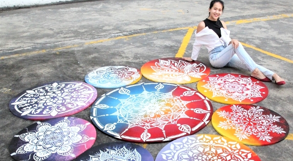 Vivian spends a week to paint a total of nine kolams.
