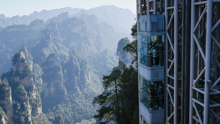 Located in Zhangjiajie Forest Park, the world's highest outdoor lift carries tourists up the cliff face that inspired the landscape for the movie "Avatar". AFP