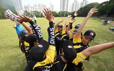 The SCC Divas Cricket Team, made up of domestic helpers from the Philippines celebrating after getting a team talk from coach Sher Lama ahead of their game against the Kong Cricket Club Cavaliers in Hong Kong. AFP