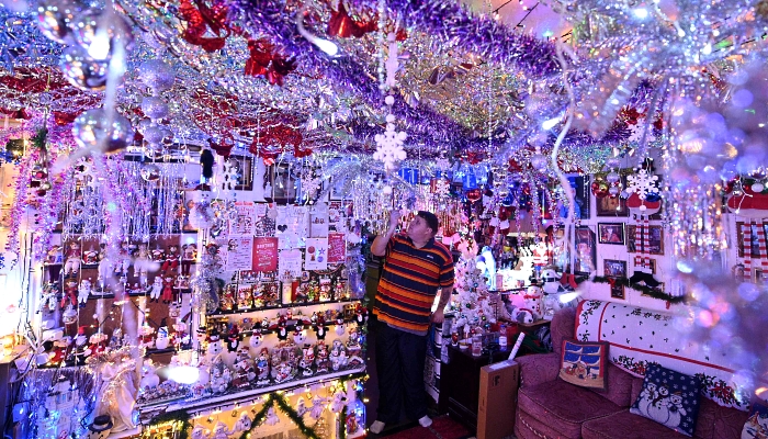 Steven Morton admires the Christmas decorations at his home in Hull in northern England. AFP