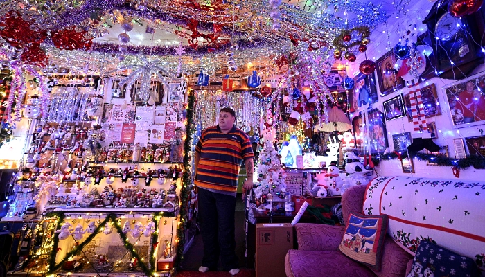 Steven Morton admires the Christmas decorations at his home in Hull in northern England. AFP