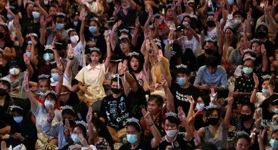Protesters hold up the three-finger salute at a pro-democracy protest in Bangkok. AFP