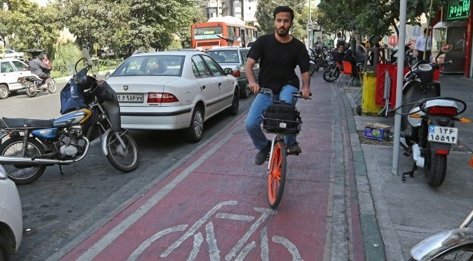 A man rides a bicycle from bike-sharing service Bdood in Tehran. AFP