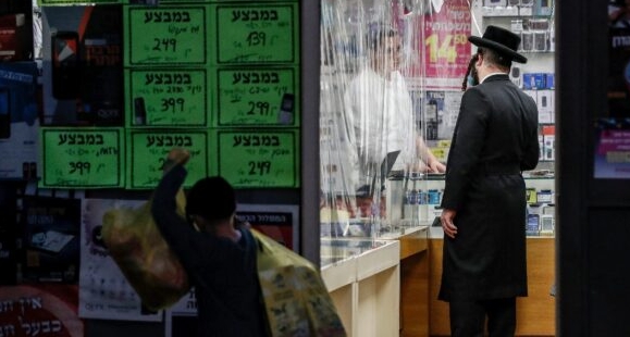 An ultra-Orthodox Jewish man inquires about a product at a shop in Jerusalem. AFP
