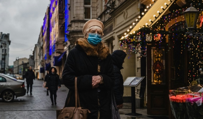 A woman wearing a face mask walks down a street in central Moscow as cases continue to climb globally. AFP