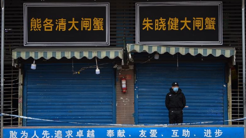 A security guard stands outside the Huanan Seafood Wholesale Market where the coronavirus was detected in Wuhan on January 24. AFP A security guard stands outside the Huanan Seafood Wholesale Market where the coronavirus was detected in Wuhan on January 24. AFP