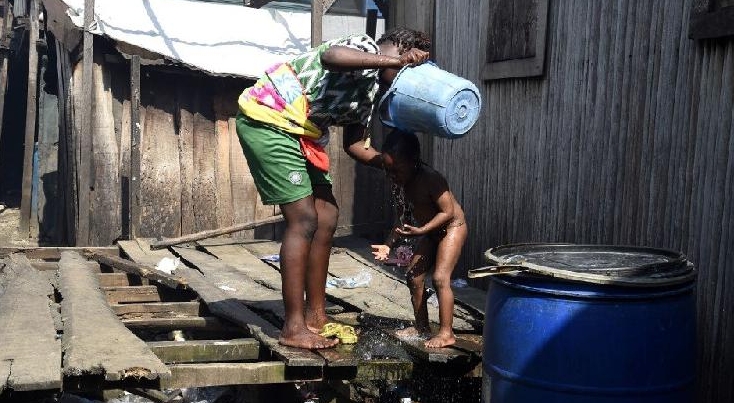 A woman washes her child in a makeshift home in the Makoko riverine slum settlement in Lagos, Nigeria. AFP A woman washes her child in a makeshift home in the Makoko riverine slum settlement in Lagos, Nigeria. AFP