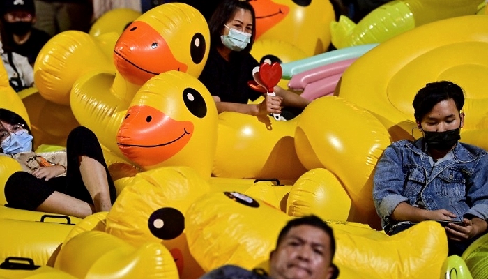 Pro-democracy protesters rest on large inflatable ducks during an anti-government rally at Lat Phrao intersection in Bangkok. AFP