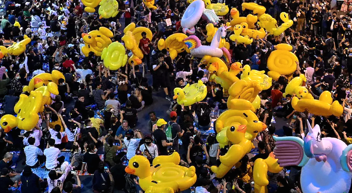 Pro-democracy protesters carry large inflatable ducks during an anti-government rally at Lat Phrao intersection in Bangkok. AFP