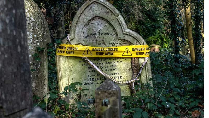 Some graves have warning tape tied round them and signs saying they are unsafe. AFP