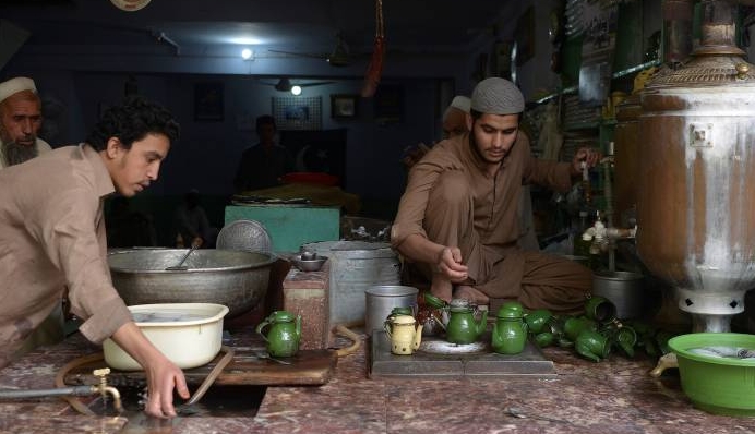 A man prepares traditional tea for customers at the oldest Qissa Khawani or 