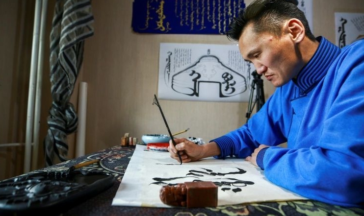 Calligrapher Ganzorig Gulguu writes Mongolian scripts at his home in Ulaanbaatar. AFP