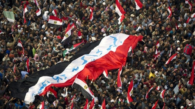Protestors carry a flag with the slogan 