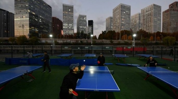 Even as temperatures drop to freezing, Beijing retirees play table tennis outside in public parks. AFP