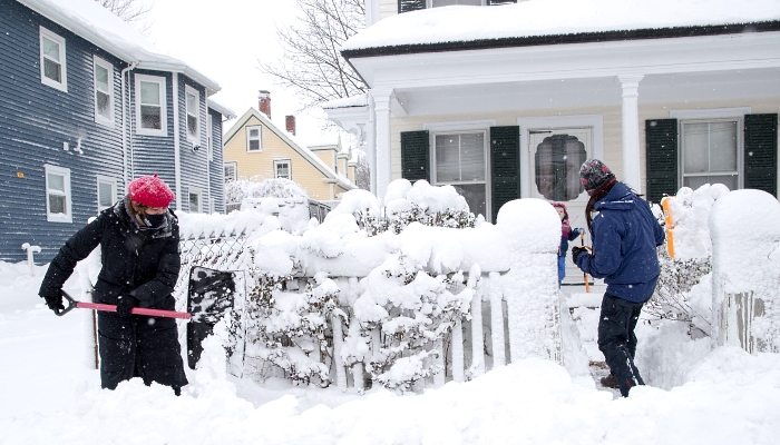 Neighbors help each other shovel the snow in Boston, Massachusetts. AFP