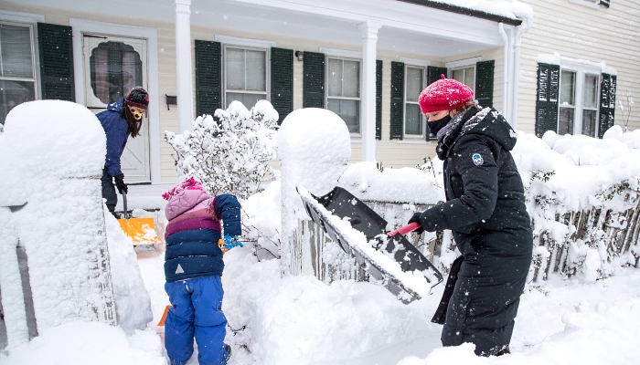 Neighbors help each other shovel the snow in Boston, Massachusetts. AFP