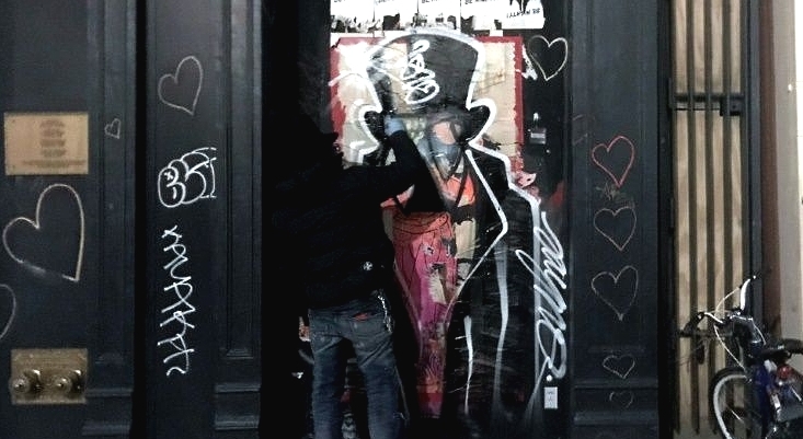 Graffiti artist Saynosleep painting on a storefront in New York. AFP