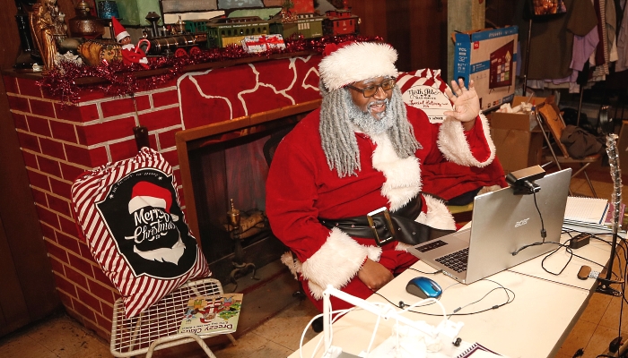 Andre Russel dresses as Santa Claus before his virtual appointment with a client at his home in Chicago. AFP