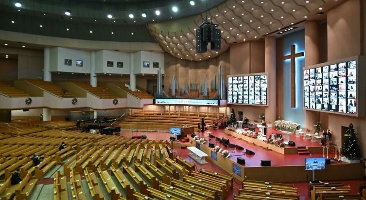 Worshippers follow a Christmas service online at the virtually empty Yoido Full Gospel Church in Seoul. AFP