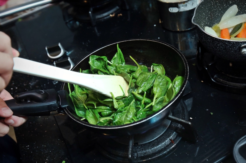 6.热锅后放入牛油，将小菠菜放入锅中炒香。