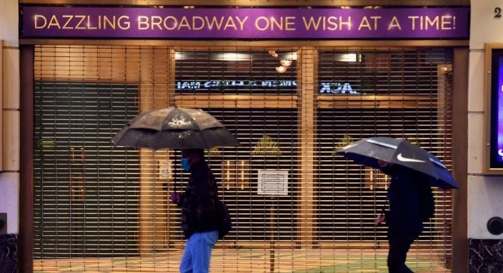 People walk past a closed Broadway theater near Time Square in New York City. AFP