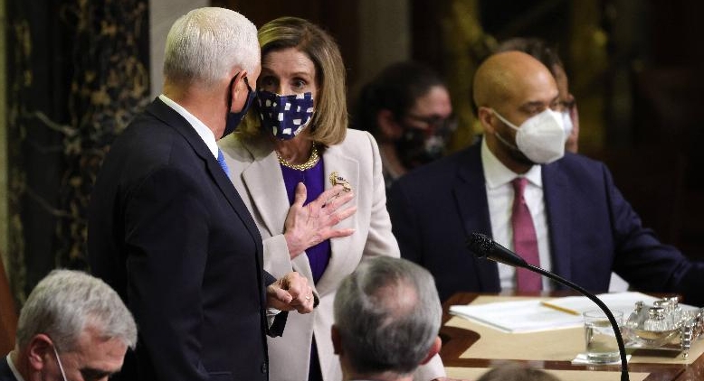 US Speaker of the House Nancy Pelosi (D-CA) talks with Vice President Mike Pence after the conclusion of the count of electoral votes in the House Chamber. AFP
