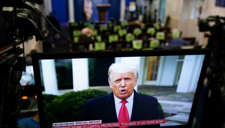 Trump is seen on TV from a video message released on Twitter which was later taken down by the platform for breaking its rules. AFP Trump is seen on TV from a video message released on Twitter which was later taken down by the platform for breaking its rules. AFP