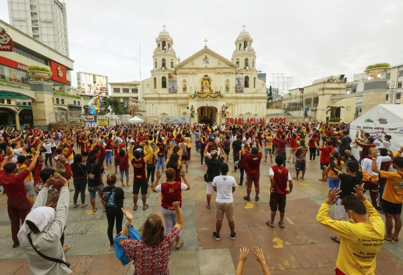 民众在马尼拉奎阿坡教堂前参与黑耶稣节弥撒活动。

