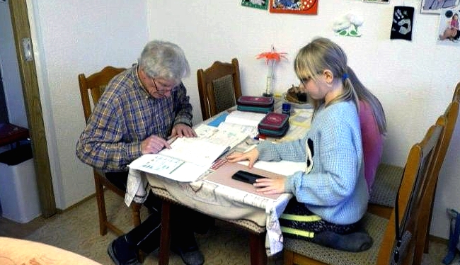 Old school: German great-granddad pitches in with home-schooling. AFP