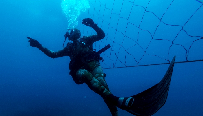 Shark activist Walter Bernardis swims along a shark net during a dive in Umkomaas near Durban. AFP