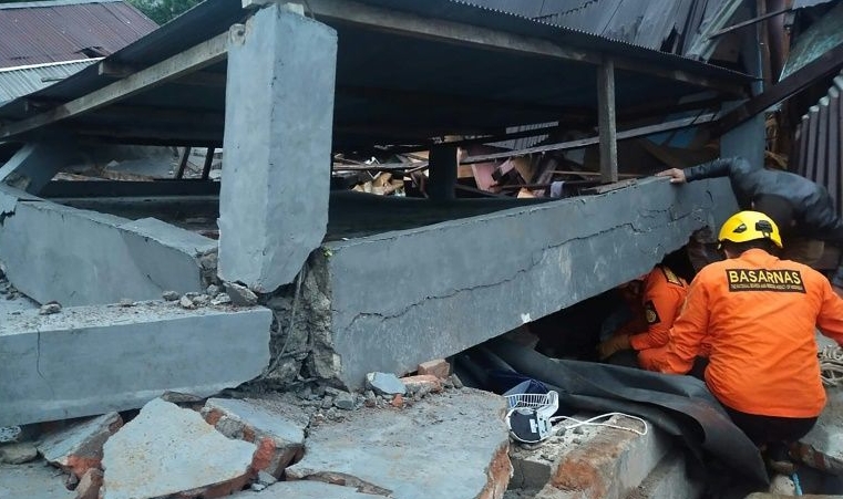 Rescuers look for survivors trapped in a collapsed building in Mamuju after the overnight quake. AFP