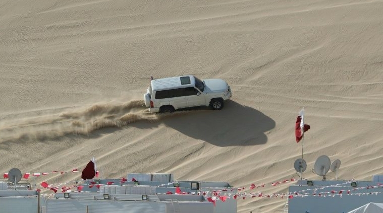 A 4x4 vehicle drives on a dune of Qatar's Sealine desert, around 63km south of Doha, where off-roading is a hugely popular pastime. AFP