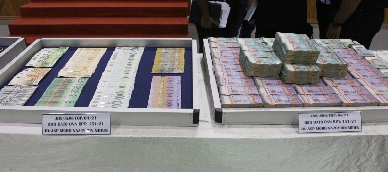 警方起获的大量现金包括令吉和外币等。
