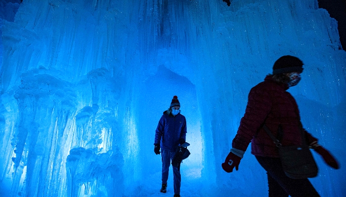 People explore the ice walls, tunnels and lights at Ice Castles in North Woodstock, New Hampshire. AFP