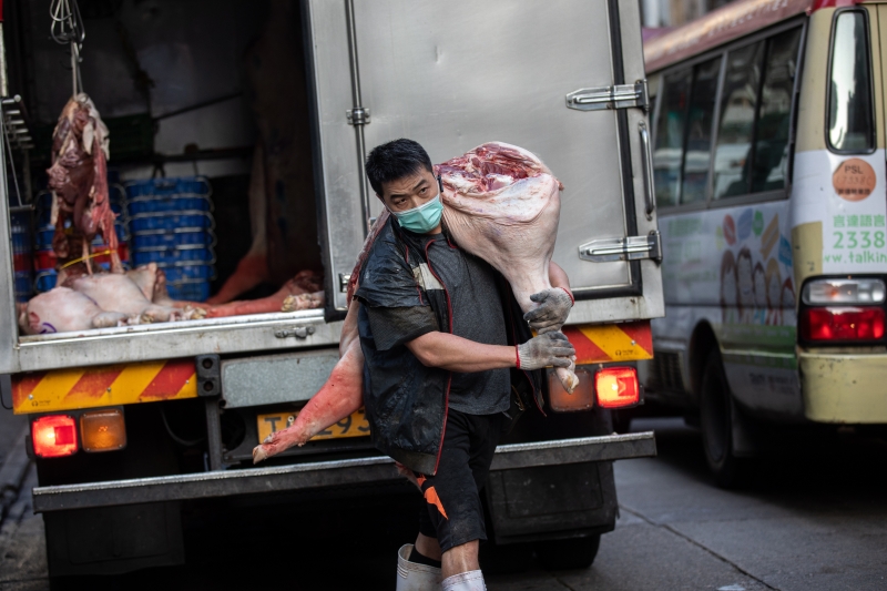 一名男子准备将猪肉运送到佐敦地区的一家猪肉摊。（图：欧新社）