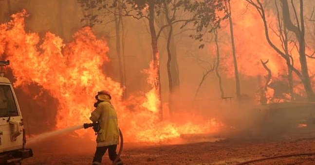 A firefighter fighting a fire outside Wooroloo near Perth. AFP