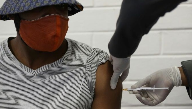 Jabbed: A South African volunteer in a trial last year of the Oxford-AstraZenca vaccine. AFP