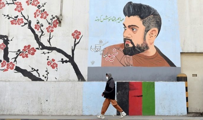 A roadside mural in Kabul pays homage to former Afghan Tolo TV presenter Yama Siawash killed in a bomb attack last November. AFP