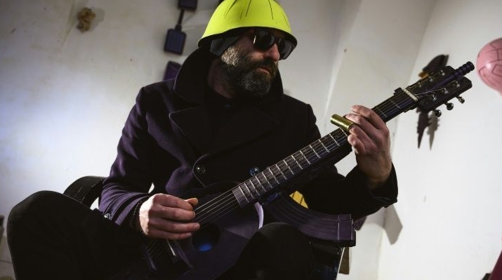 War veteran and visual artist Sarovic has taken to playing a guitar made out of an M70 rifle. AFP