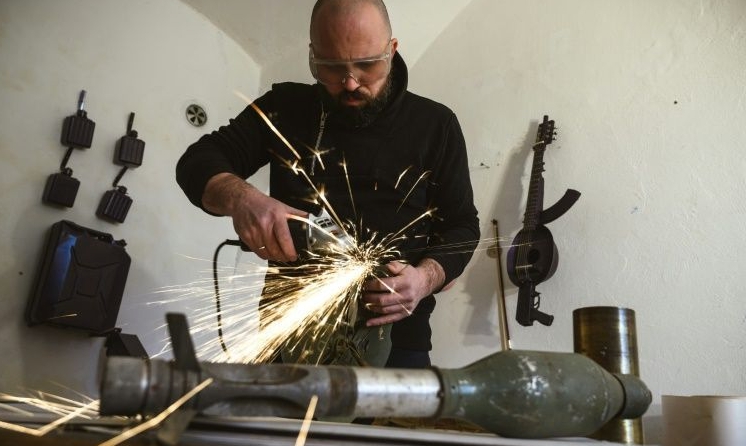 Macura transforms decommissioned weapons into musical instruments. AFP