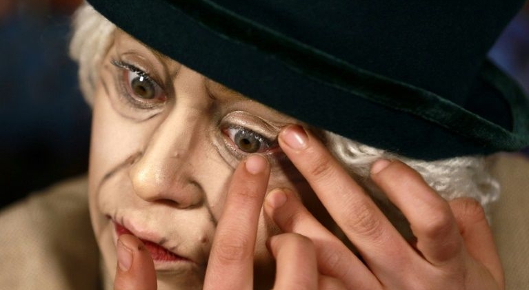 Make-up artist Alaa Bliha applies colored eye lenses to complete her imitation make-up to resemble Queen Elizabeth II. AFP