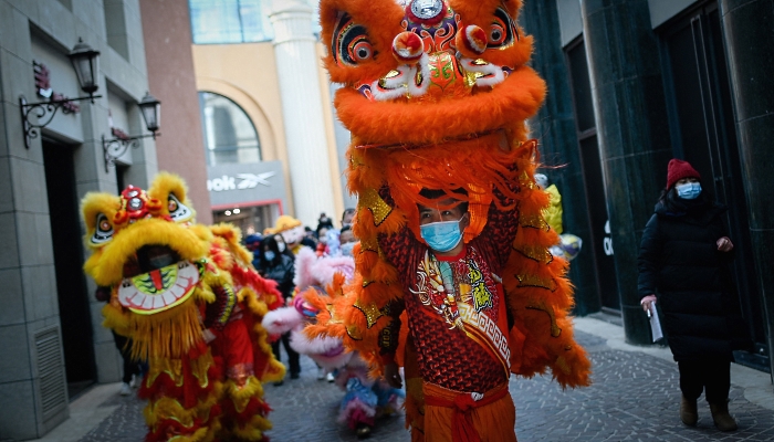 Members of a lion dance troupe perform in a mall in Beijing on the fifth day of Lunar New Year. AFP