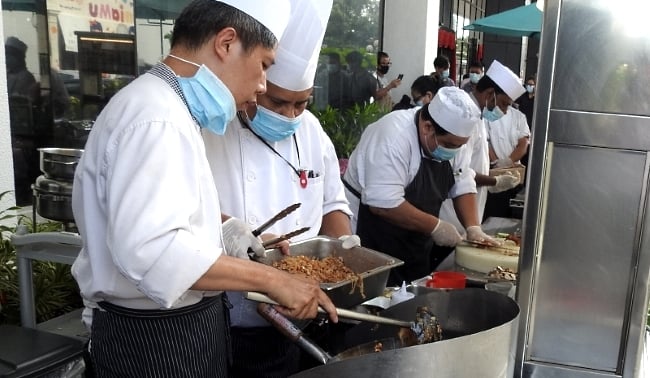 Hotel chefs preparing the food in the open air. Hotel chefs preparing the food in the open air.
