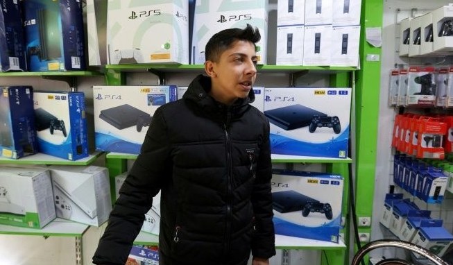 A vendor sells consoles at a shop in Tehran's central market. AFP