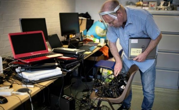 Damian Griffiths founded a community group to fix old computers that are then donated to kids who need them to do online lessons during lockdown. AFP